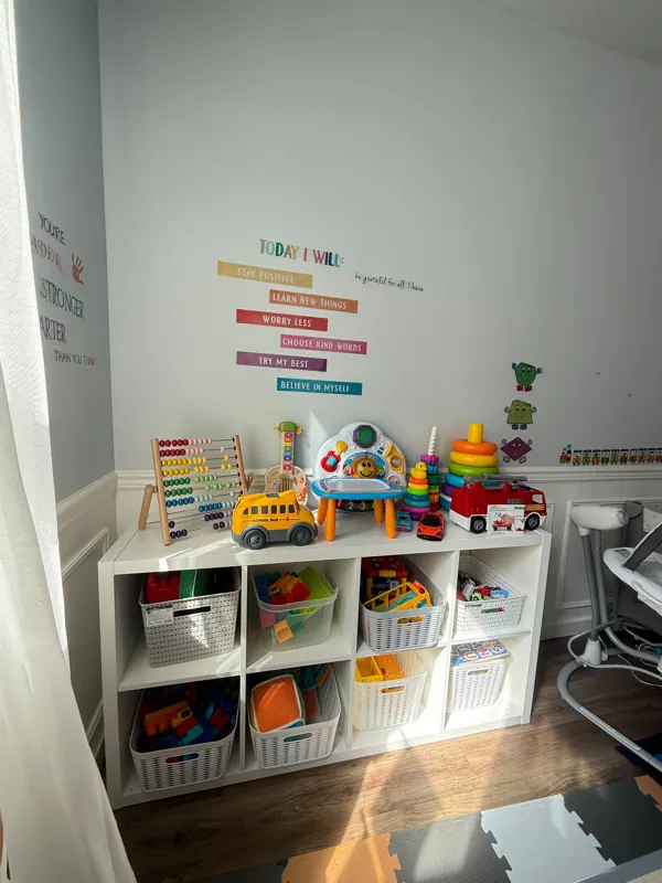 Learning shelf with an abacus, toys and a “Today I will” positivity wall